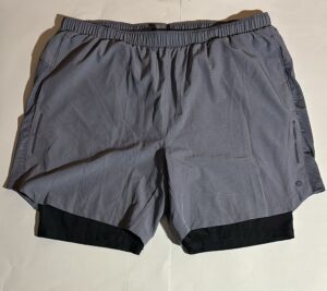 Gray AB3 running shorts with black compression liner. Ideal for workouts and athletic activities.