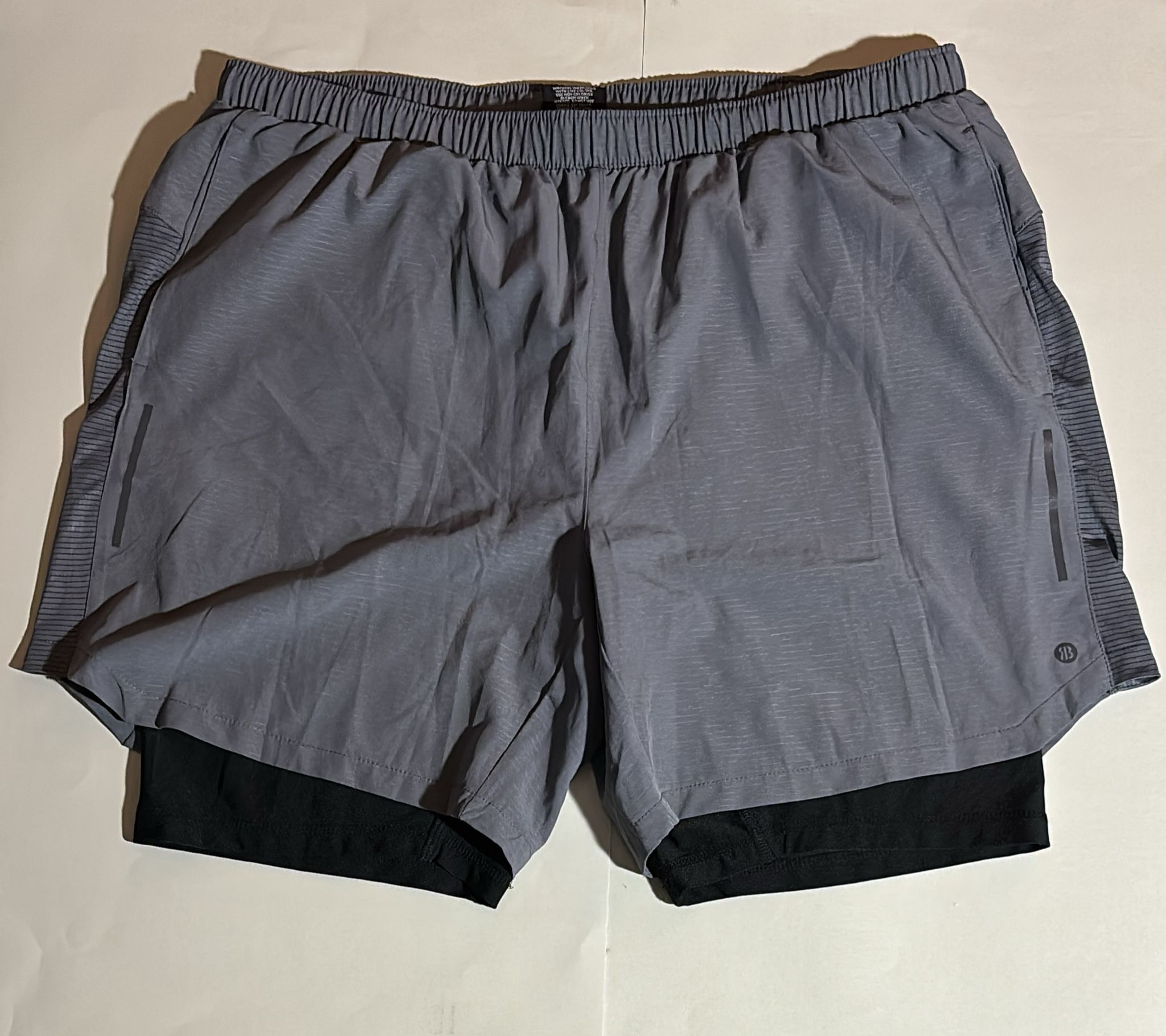 Gray AB3 running shorts with black compression liner. Ideal for workouts and athletic activities.