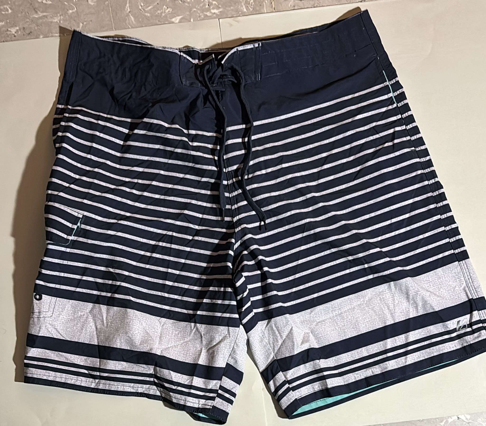 Striped swim trunks with a drawstring.