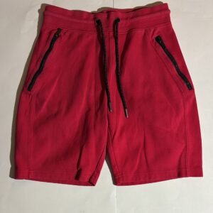 Red athletic shorts with black drawstring and zippered pockets.